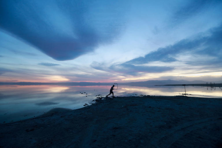 A person walks along Bombay Beach